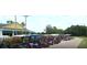Line of parked golf carts with a building and trees in the background at 32512 Oak Park Dr, Leesburg, FL 34748