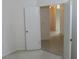 Hallway with tile floors and white doors, providing access to other areas of the home at 32512 Oak Park Dr, Leesburg, FL 34748