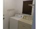 Laundry room featuring a washer, dryer, wire shelving and a window with blinds at 32512 Oak Park Dr, Leesburg, FL 34748