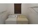 Laundry room featuring a washer, dryer, wire shelving and a window with blinds at 32512 Oak Park Dr, Leesburg, FL 34748