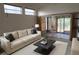 Bright living room with a couch, coffee table, and sliding doors leading to an enclosed patio at 32512 Oak Park Dr, Leesburg, FL 34748