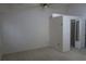 Bedroom with neutral carpet leading to bathroom and closet at 32512 Oak Park Dr, Leesburg, FL 34748