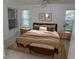 Comfortable main bedroom featuring windows, carpet flooring, ceiling fan, and natural light at 32512 Oak Park Dr, Leesburg, FL 34748