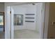 An empty office with floating shelves and a window with natural light at 32512 Oak Park Dr, Leesburg, FL 34748