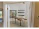 Bright home office featuring floating shelves, a window, ceiling fan, and a desk with a comfy chair at 32512 Oak Park Dr, Leesburg, FL 34748