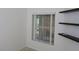 The office offers a view of the outside with the window and floating shelves at 32512 Oak Park Dr, Leesburg, FL 34748
