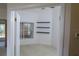 A bright empty office with floating shelves and a window with natural light at 32512 Oak Park Dr, Leesburg, FL 34748