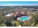 Aerial view of community clubhouse, pool, and surrounding area at 3713 Doune Way, Clermont, FL 34711