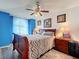 Serene bedroom with a wooden sleigh bed and blue walls at 3713 Doune Way, Clermont, FL 34711