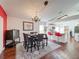 Elegant dining room with a chandelier, red accent wall, and seating for six at 3713 Doune Way, Clermont, FL 34711