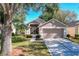 Attractive single-story house with landscaped lawn and driveway at 3713 Doune Way, Clermont, FL 34711
