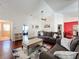 Living room with hardwood floors, comfortable seating, and access to other rooms at 3713 Doune Way, Clermont, FL 34711