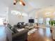 Bright living room features hardwood floors, comfortable seating, and a large TV at 3713 Doune Way, Clermont, FL 34711