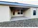 Covered back patio with access door and view of yard at 4456 Sagefield Dr, Harmony, FL 34773