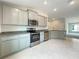 Modern kitchen with stainless steel appliances and ample cabinet space at 4456 Sagefield Dr, Harmony, FL 34773