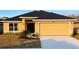 Newly constructed single-story house with a two-car garage and manicured lawn at 4464 Sagefield Dr, Harmony, FL 34773