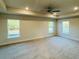 Large main bedroom with ceiling fan and neutral carpeting at 4464 Sagefield Dr, Harmony, FL 34773
