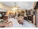 Comfortable living room featuring a fireplace, an open layout, and ample seating for Gathering and friends at 489 Sugar Ridge Ct, Longwood, FL 32779