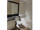 A bright bathroom featuring a toilet, vanity with dark countertops, and a combined tub and shower at 5548 Metrowest Blvd # 101, Orlando, FL 32811