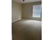 Spacious bedroom with neutral carpeting and window at 5548 Metrowest Blvd # 101, Orlando, FL 32811