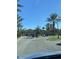 Community entrance with gated access and palm trees at 5548 Metrowest Blvd # 101, Orlando, FL 32811