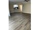 Spacious living room with vinyl flooring and kitchen bar at 5548 Metrowest Blvd # 101, Orlando, FL 32811
