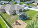 Large backyard with patio, trampoline, and firepit at 5681 Western Sun Dr, St Cloud, FL 34771