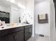 Double vanity bathroom with dark brown cabinets at 5681 Western Sun Dr, St Cloud, FL 34771
