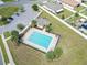 Aerial view of community pool with surrounding patio and landscaping at 5681 Western Sun Dr, St Cloud, FL 34771