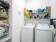 Laundry room with washer, dryer, and shelving at 5681 Western Sun Dr, St Cloud, FL 34771