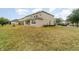Large backyard with a two-story house and partial view of the neighborhood at 5791 Covington Cove Way, Orlando, FL 32829
