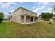Large backyard with patio and two-story house at 5791 Covington Cove Way, Orlando, FL 32829