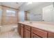 Clean bathroom, featuring a tub, toilet and wood cabinets at 5791 Covington Cove Way, Orlando, FL 32829