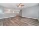 Spacious bedroom with wood-look flooring and ceiling fan at 5791 Covington Cove Way, Orlando, FL 32829