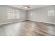 Bedroom with ceiling fan and grey wood-look flooring at 5791 Covington Cove Way, Orlando, FL 32829