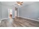 Bedroom with wood-look flooring and ceiling fan at 5791 Covington Cove Way, Orlando, FL 32829