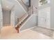 Two-story foyer with tile floors and wooden staircase at 5791 Covington Cove Way, Orlando, FL 32829