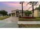 Two-story house with a paved driveway and landscaping at 5791 Covington Cove Way, Orlando, FL 32829