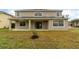 Two-story house with covered patio and yard at 5791 Covington Cove Way, Orlando, FL 32829