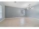 Bright living room with neutral walls and tile flooring at 5791 Covington Cove Way, Orlando, FL 32829