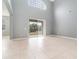 Spacious living room with tile floors and sliding glass doors at 5791 Covington Cove Way, Orlando, FL 32829