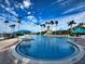 Community pool with lounge chairs and palm trees at 5791 Covington Cove Way, Orlando, FL 32829