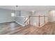 Spacious upstairs hallway with laminate flooring and elegant chandelier at 5791 Covington Cove Way, Orlando, FL 32829
