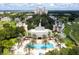 Aerial view of resort featuring a pool, palm trees, and well-maintained grounds at 7925 Putting Green Way, Reunion, FL 34747