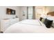 Comfortable bedroom featuring a king-sized bed, dresser and TV at 7925 Putting Green Way, Reunion, FL 34747