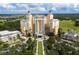 A multi-story building is surrounded by manicured lawns, palm trees, and lush green fairways at 7925 Putting Green Way, Reunion, FL 34747