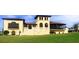 Stunning clubhouse featuring a tower, elegant architecture, and lush green surroundings at 7925 Putting Green Way, Reunion, FL 34747