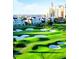 Picturesque golf course with modern resort and residences in the background at 7925 Putting Green Way, Reunion, FL 34747
