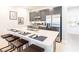 Modern kitchen with sleek gray cabinetry, stainless steel appliances, and a spacious island with seating at 7925 Putting Green Way, Reunion, FL 34747