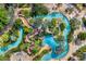 An aerial view features a lazy river with lush landscaping and water features at 7925 Putting Green Way, Reunion, FL 34747